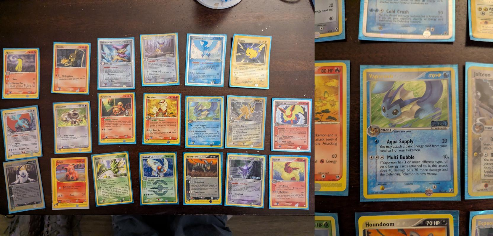 A selection of cards from Altissimo’s collection, including a Vaporeon card from EX Unseen Forces