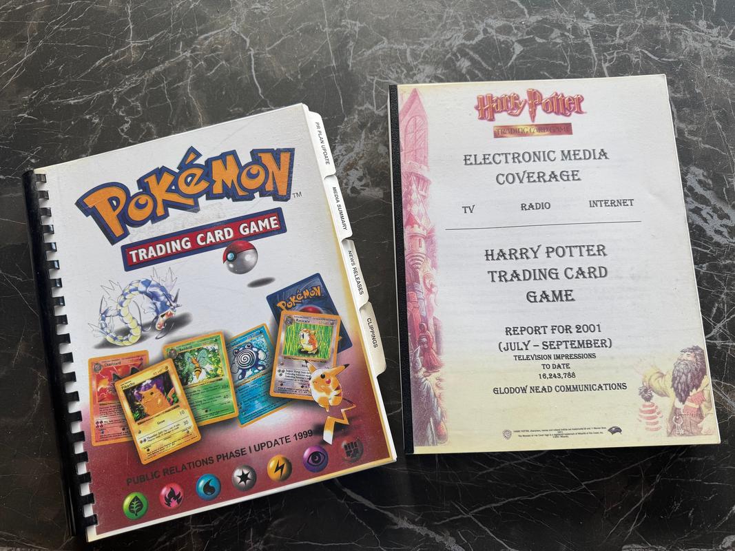 Carol provided a photo of her books of press clippings from her time working at Wizards of the Coast on Pokémon and Harry Potter