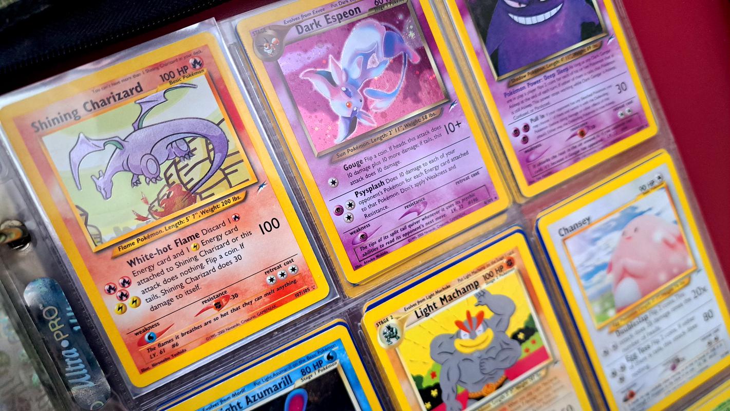 A photograph featuring some of Jay’s Pokémon trading cards, including his Shining Charizard card
