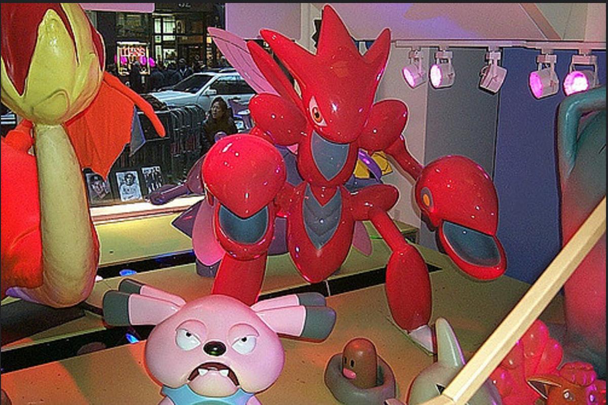 A photograph of some of the Pokémon animatronics and figures found in the original Pokémon Center New York store, including a Scizor, Snubbull, Digglet, Vulpix and Charizard