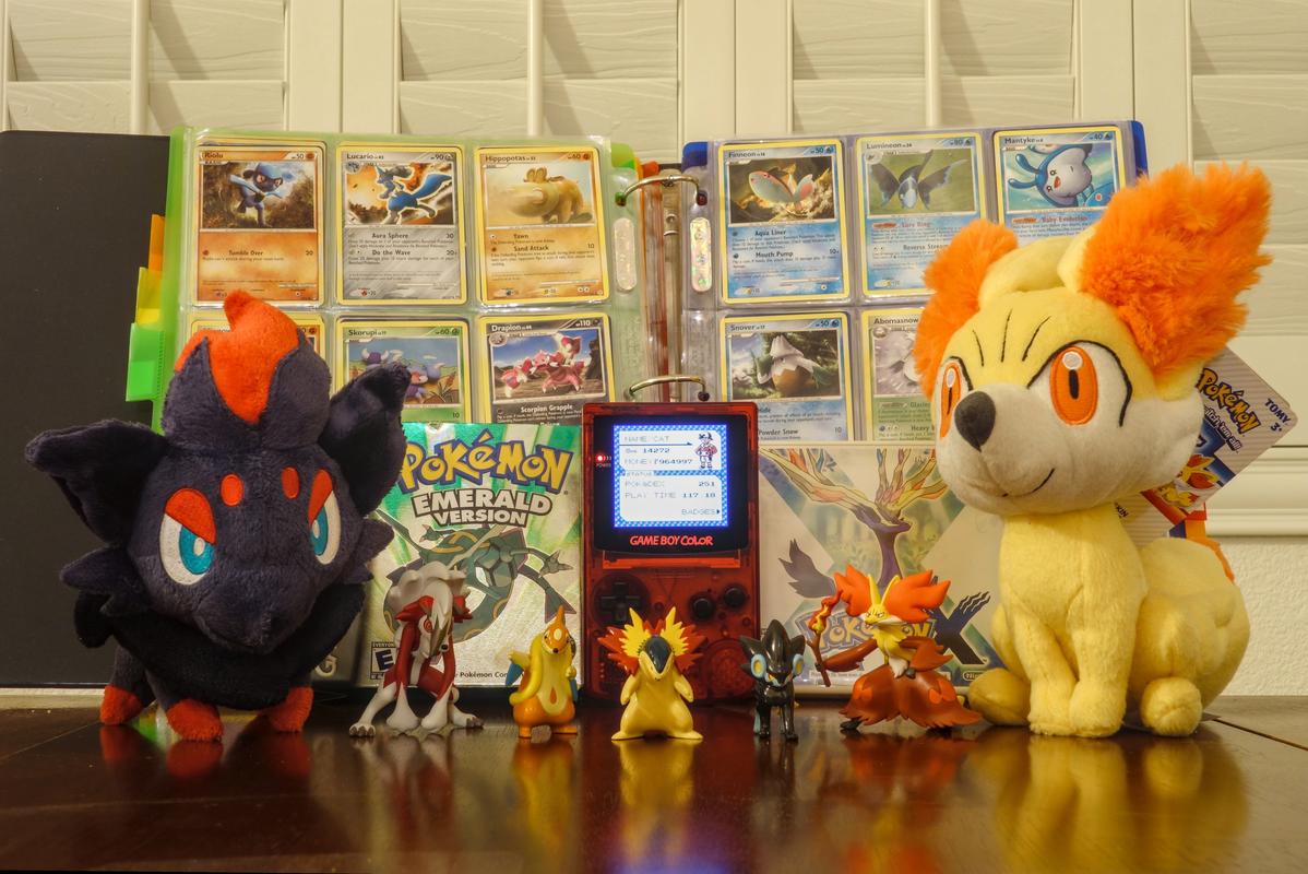 Cat's "CardDex" with plushies, games, and figures