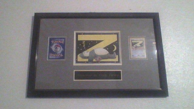 Craig kindly sent over photographs of the prize he received from Wizards of the Coast: his original artwork framed alongside the Snorlax promo card. A copy of this was given to Craig's League and hung inside the manager's office for several years. When Craig left the league, he asked if he could have it, and they agreed. He gave the copy to his mother.