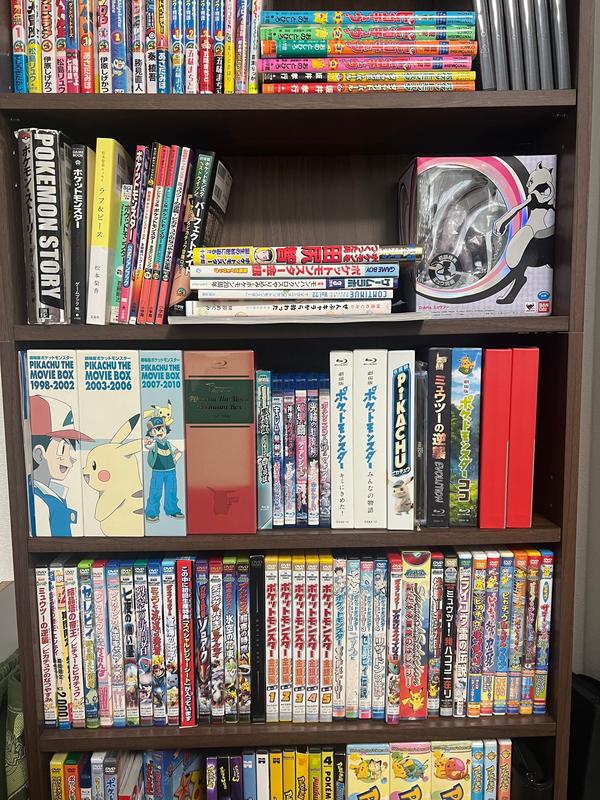 Dogasu has an impressive collection of Pokémon items! Here's a photograph of his Blu-rays and DVDs