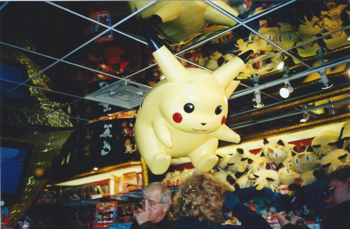 A photograph focused on a giant Pikachu figure hanging from the ceiling, taken at FAO Schwarz from around November/December 2000