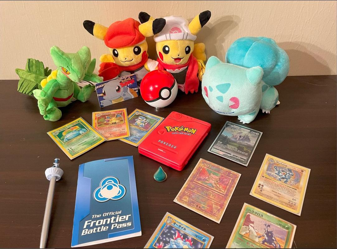 ThunderHero’s collection of Pokémon items, including an electronic Pokédex toy, Pokémon cards featuring some of his favourite creatures, and a Frontier Battle Pass booklet